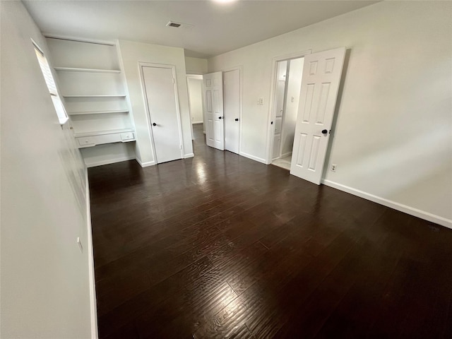 10447 Winding Trail Rd, La Porte, TX 77571 - unfurnished bedroom featuring dark wood-style floors and baseboards