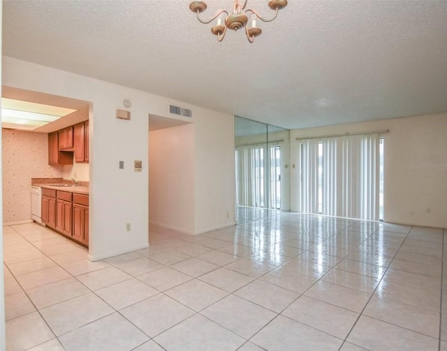 2818 S Bartell Dr S Unit 6, Houston, TX 77054 - spare room with a chandelier, a textured ceiling, and light tile patterned flooring