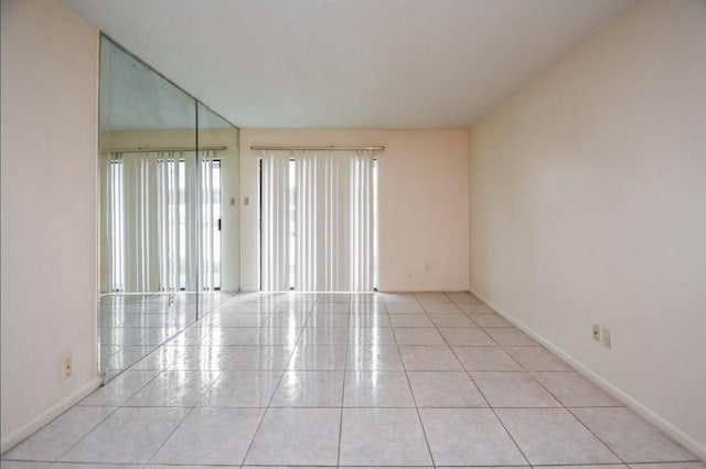 2818 S Bartell Dr S Unit 6, Houston, TX 77054 - empty room with light tile patterned floors and baseboards