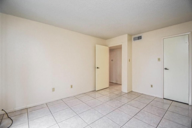 2818 S Bartell Dr S Unit 6, Houston, TX 77054 - empty room with light tile patterned floors and a textured ceiling