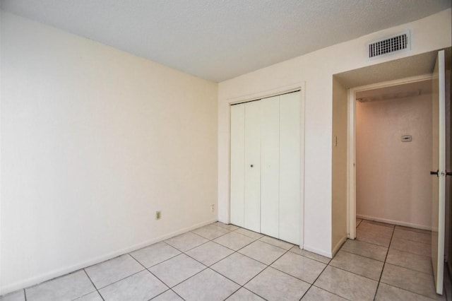 2818 S Bartell Dr S Unit 6, Houston, TX 77054 - unfurnished bedroom with light tile patterned floors and a closet