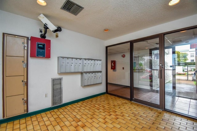 2818 S Bartell Dr S Unit 6, Houston, TX 77054 - unfurnished room with mail area, a textured ceiling, and recessed lighting