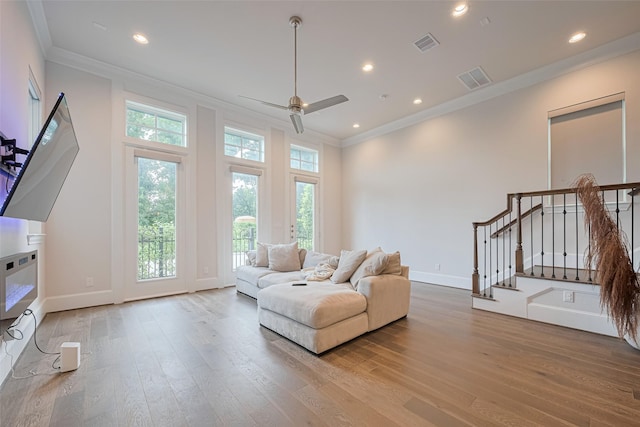 5308 S Capitol St, Houston, TX 77023 - living area featuring crown molding, wood finished floors, a ceiling fan, stairway, and recessed lighting