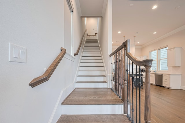 5308 S Capitol St, Houston, TX 77023 - staircase featuring ornamental molding, wood finished floors, and recessed lighting
