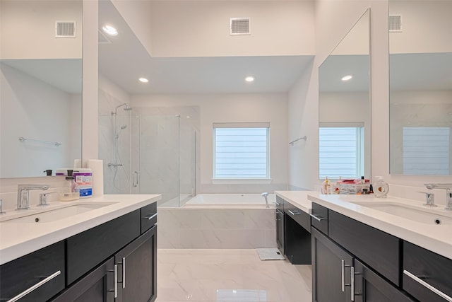 5308 S Capitol St, Houston, TX 77023 - bathroom featuring a marble finish shower, recessed lighting, a garden tub, two vanities, and marble finish floors