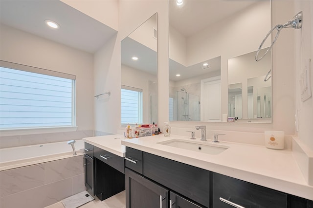 5308 S Capitol St, Houston, TX 77023 - full bath featuring vanity, a bath, a stall shower, and recessed lighting