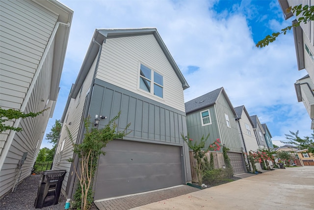 5308 S Capitol St, Houston, TX 77023 - view of property exterior with board and batten siding, a garage, and driveway
