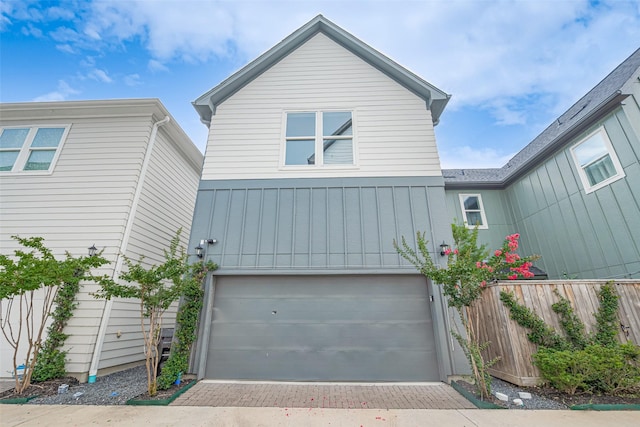 5308 S Capitol St, Houston, TX 77023 - view of front of house featuring an attached garage, decorative driveway, and board and batten siding