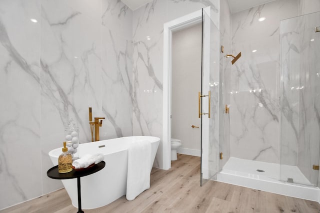 5906 Saint Augustine St Unit C, Houston, TX 77021 - bathroom with a marble finish shower, a soaking tub, and wood finished floors