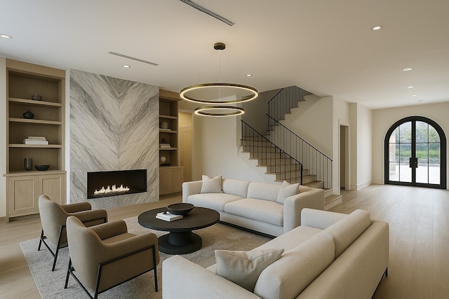6911 Hartland Ave, Houston, TX 77055 - living area with built in shelves, light wood-style floors, stairs, recessed lighting, and a fireplace