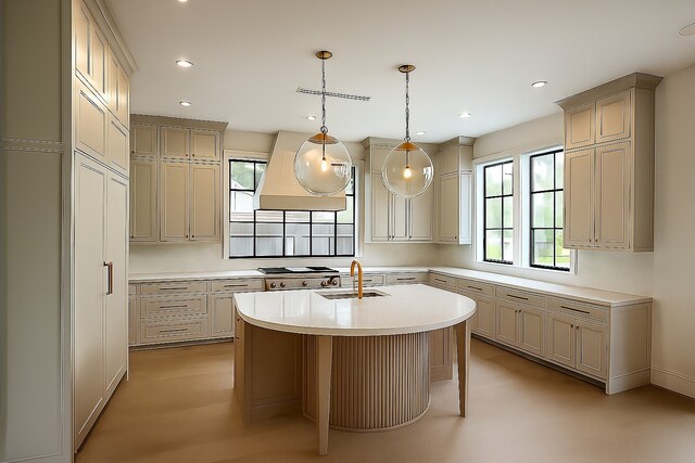 6911 Hartland Ave, Houston, TX 77055 - kitchen with light countertops, custom range hood, a kitchen island with sink, hanging light fixtures, and recessed lighting