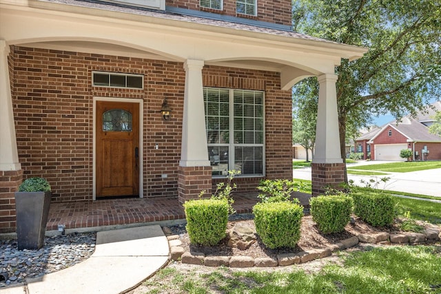2551 Goldeneye Ln, League City, TX 77573 - doorway to property featuring a porch and brick siding