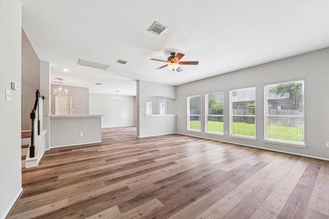 2551 Goldeneye Ln, League City, TX 77573 - unfurnished living room with a chandelier, wood finished floors, and a ceiling fan