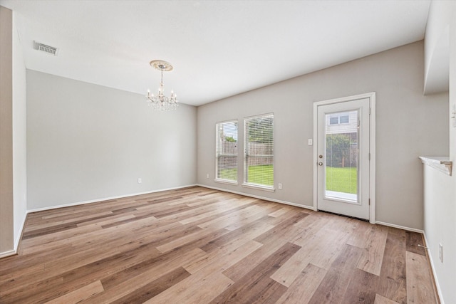 2551 Goldeneye Ln, League City, TX 77573 - unfurnished dining area featuring a chandelier and light wood-style floors