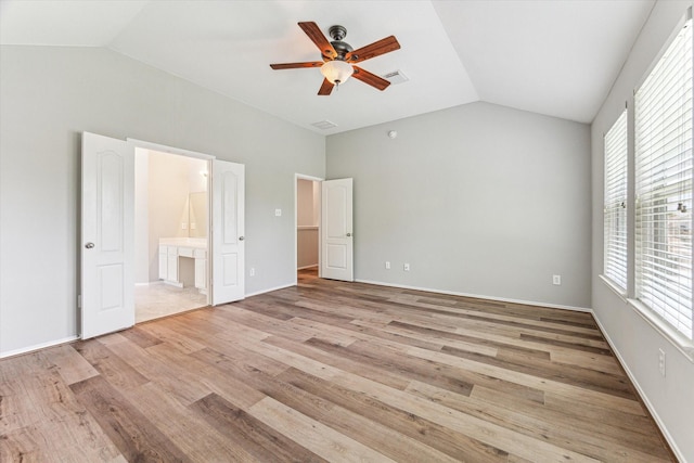 2551 Goldeneye Ln, League City, TX 77573 - unfurnished bedroom featuring lofted ceiling, light wood-style flooring, ensuite bath, and a ceiling fan