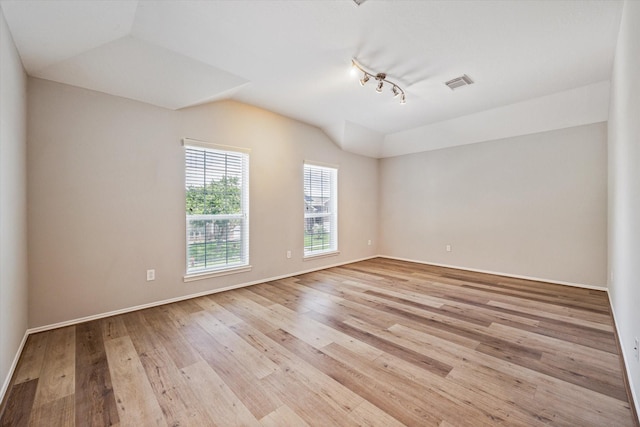 2551 Goldeneye Ln, League City, TX 77573 - empty room featuring light wood-type flooring, lofted ceiling, and track lighting
