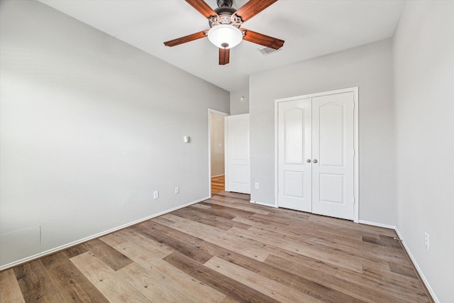 2551 Goldeneye Ln, League City, TX 77573 - unfurnished bedroom with wood finished floors, a closet, and ceiling fan