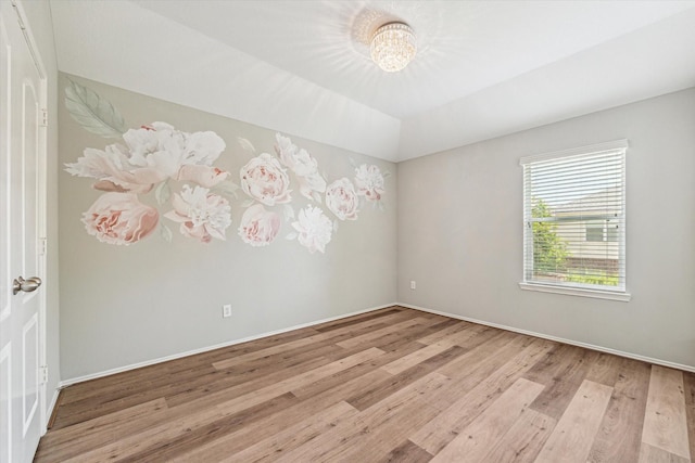 2551 Goldeneye Ln, League City, TX 77573 - empty room featuring wood finished floors and a chandelier
