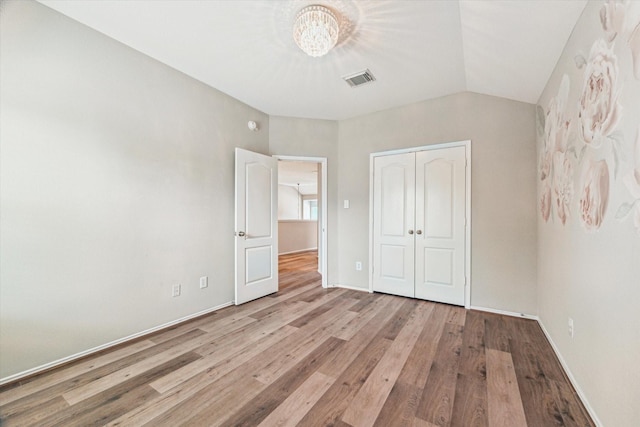 2551 Goldeneye Ln, League City, TX 77573 - unfurnished bedroom with a chandelier, wood finished floors, and a closet