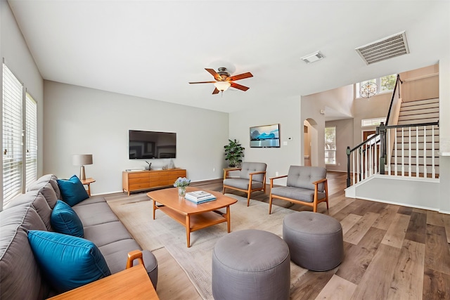 2551 Goldeneye Ln, League City, TX 77573 - living area featuring a ceiling fan, stairs, wood finished floors, and arched walkways