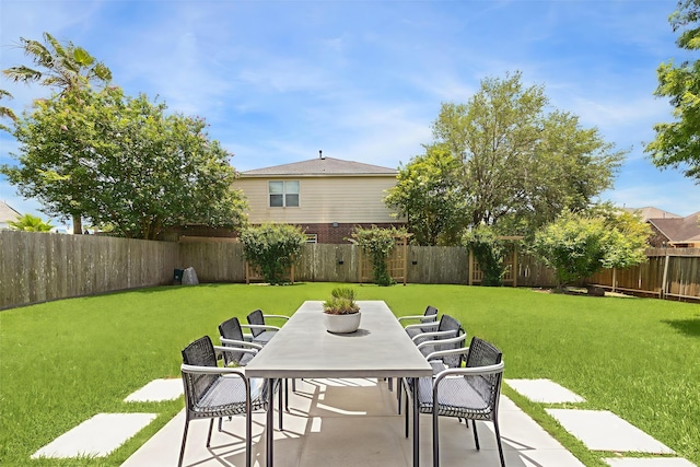 2551 Goldeneye Ln, League City, TX 77573 - fenced backyard with outdoor dining space and a patio