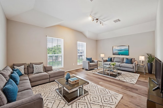 2551 Goldeneye Ln, League City, TX 77573 - living area featuring lofted ceiling, wood finished floors, and track lighting
