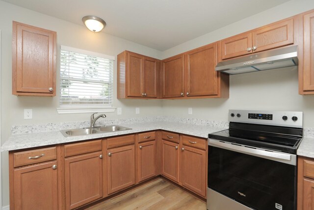 1440 Shepherd St, Hempstead, TX 77445 - kitchen featuring stainless steel electric range, under cabinet range hood, light wood-style floors, and light countertops