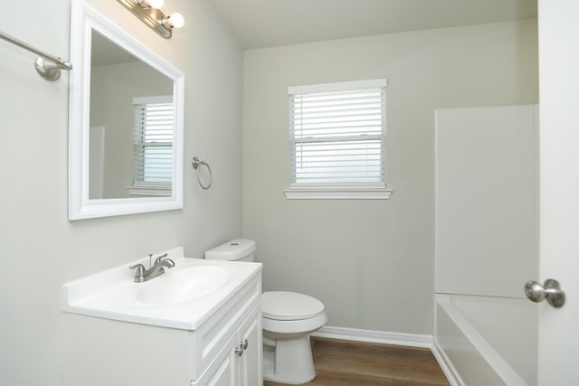 1440 Shepherd St, Hempstead, TX 77445 - full bathroom with vanity, plenty of natural light, a bath, and wood finished floors