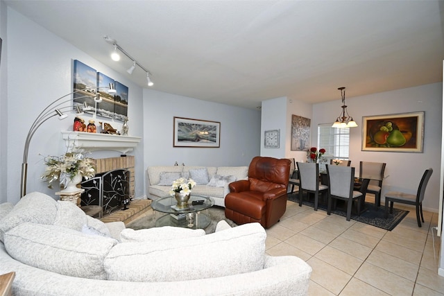 9809 Richmond Ave Unit G1, Houston, TX 77042 - living room with light tile patterned floors, a brick fireplace, and rail lighting