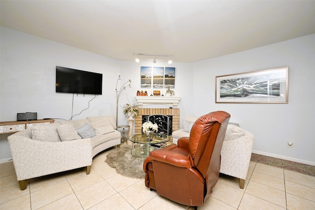 9809 Richmond Ave Unit G1, Houston, TX 77042 - living room featuring rail lighting, light tile patterned floors, and a fireplace