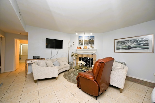 9809 Richmond Ave Unit G1, Houston, TX 77042 - living room featuring rail lighting, light tile patterned floors, and a brick fireplace