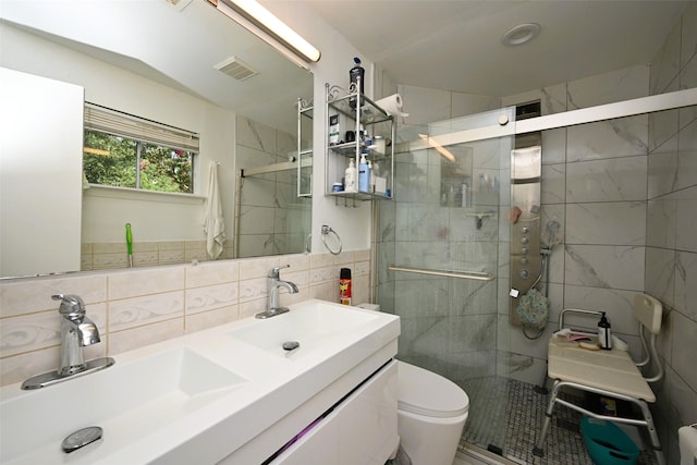 9809 Richmond Ave Unit G1, Houston, TX 77042 - full bathroom featuring tile walls, a stall shower, and double vanity