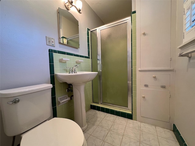 4602 Redstart St, Houston, TX 77035 - bathroom featuring a shower stall, marble finish flooring, and tile walls