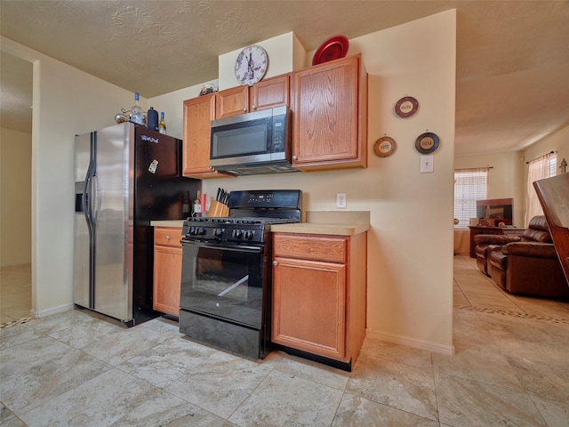 21603 Micheala Way, Humble, TX 77338 - kitchen featuring appliances with stainless steel finishes, open floor plan, and light countertops