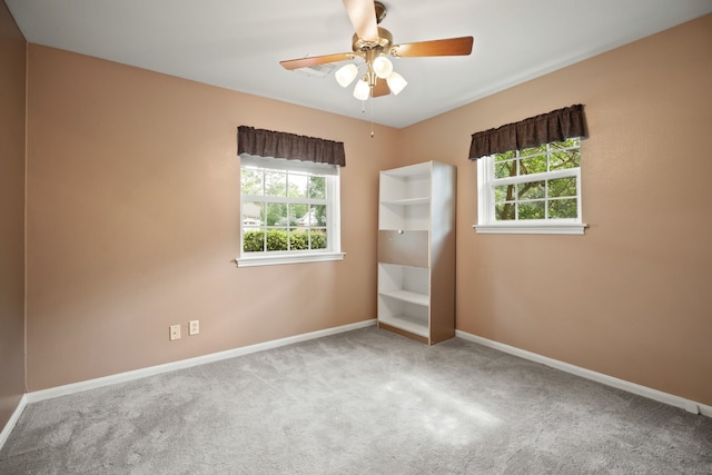 111 Whispering Oaks Dr, Seabrook, TX 77586 - empty room with carpet flooring, plenty of natural light, and a ceiling fan