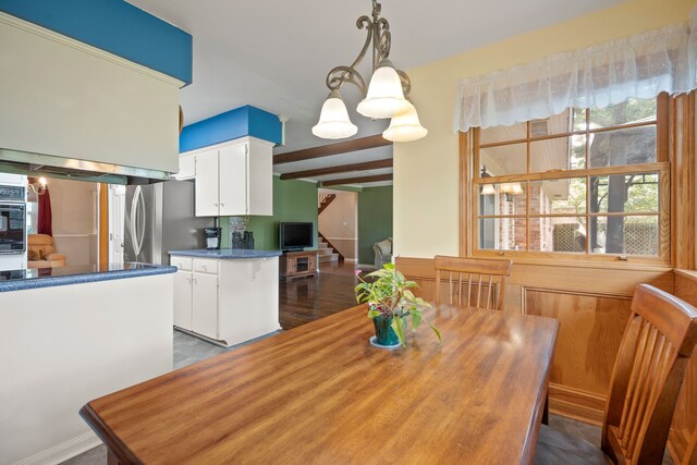 111 Whispering Oaks Dr, Seabrook, TX 77586 - dining room featuring stairs, beam ceiling, and dark wood-type flooring