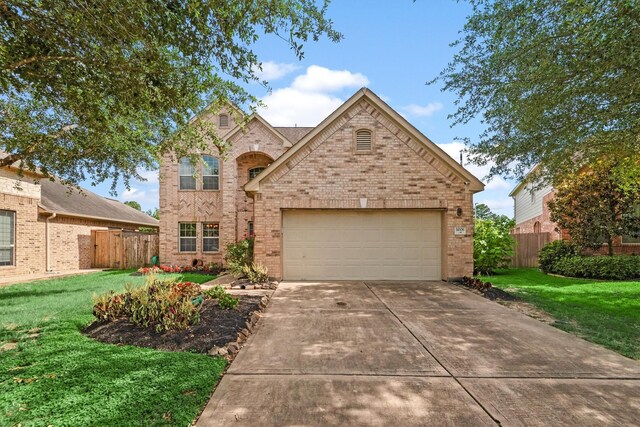 14306 Prosper Ridge Dr, Cypress, TX 77429 - traditional-style home featuring driveway, brick siding, and an attached garage