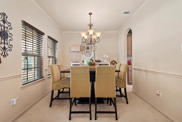 14306 Prosper Ridge Dr, Cypress, TX 77429 - dining area featuring a chandelier, light colored carpet, arched walkways, and crown molding