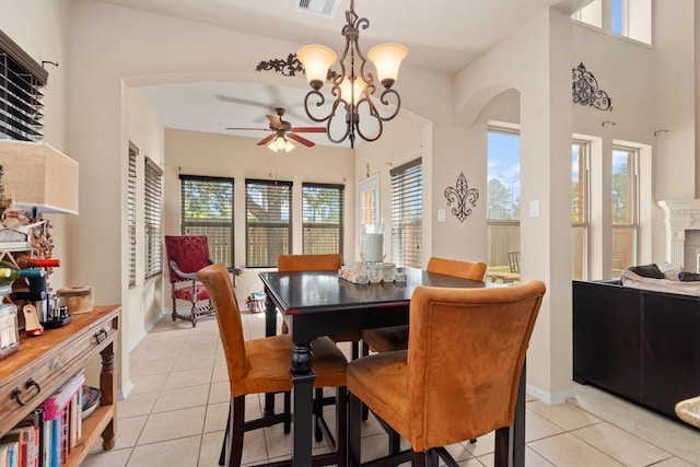 14306 Prosper Ridge Dr, Cypress, TX 77429 - dining room featuring ceiling fan, light tile patterned floors, arched walkways, and a chandelier