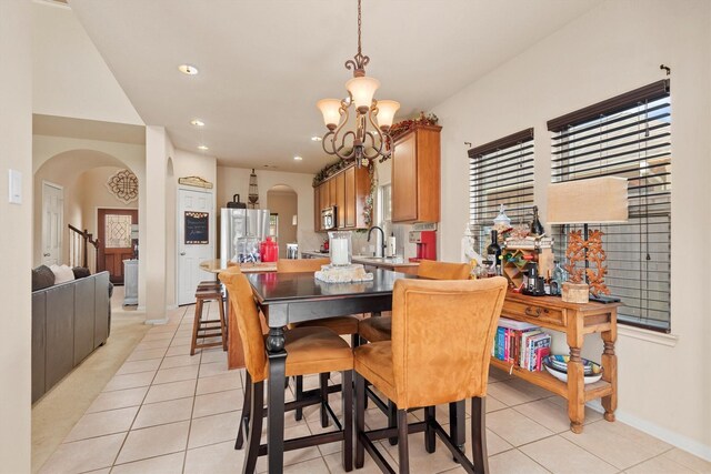 14306 Prosper Ridge Dr, Cypress, TX 77429 - dining area featuring arched walkways, a chandelier, light tile patterned floors, and recessed lighting