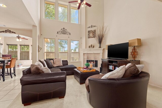 14306 Prosper Ridge Dr, Cypress, TX 77429 - living area with a ceiling fan, a tile fireplace, and a towering ceiling