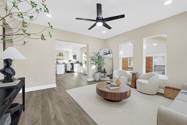2346 Delafield St, Houston, TX 77023 - living area featuring a ceiling fan, wood finished floors, and recessed lighting