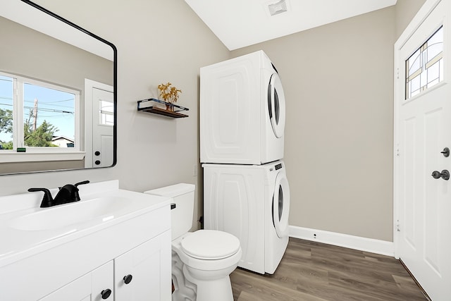 2346 Delafield St, Houston, TX 77023 - bathroom featuring stacked washer / drying machine, wood finished floors, and vanity
