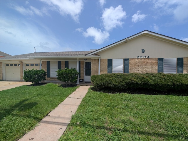 2004 24th St, Galveston, TX 77550 - ranch-style house featuring brick siding, a front lawn, an attached garage, and driveway