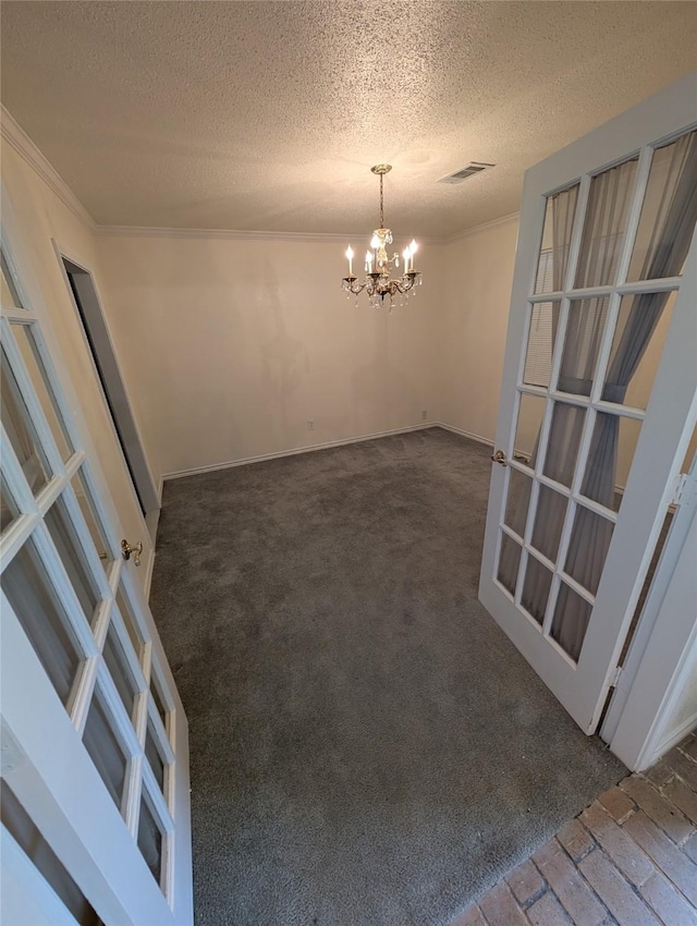 2004 24th St, Galveston, TX 77550 - unfurnished dining area with a chandelier, crown molding, a textured ceiling, and carpet floors