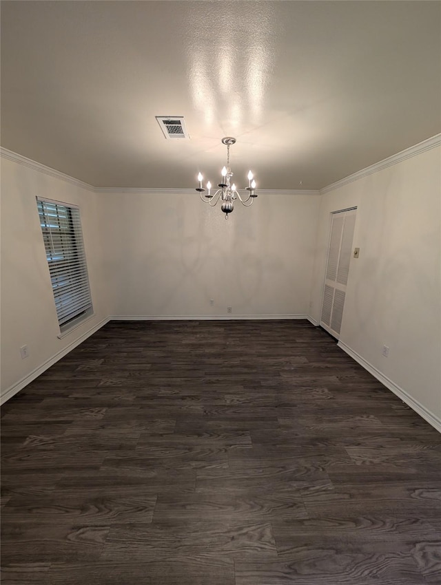 2004 24th St, Galveston, TX 77550 - unfurnished room with a chandelier, crown molding, and dark wood-type flooring