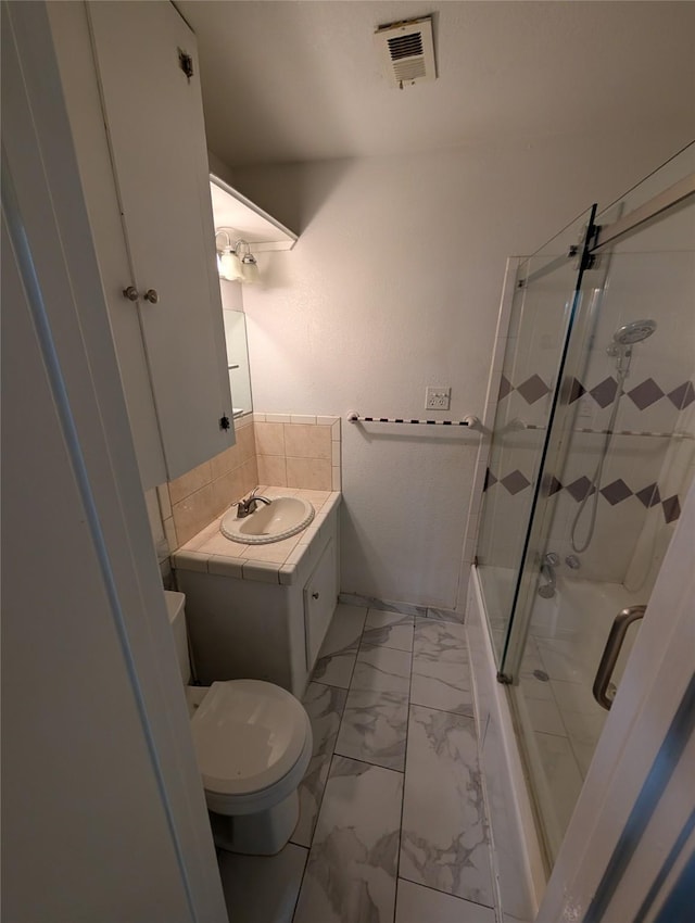 2004 24th St, Galveston, TX 77550 - bathroom with vanity, marble finish floors, and backsplash