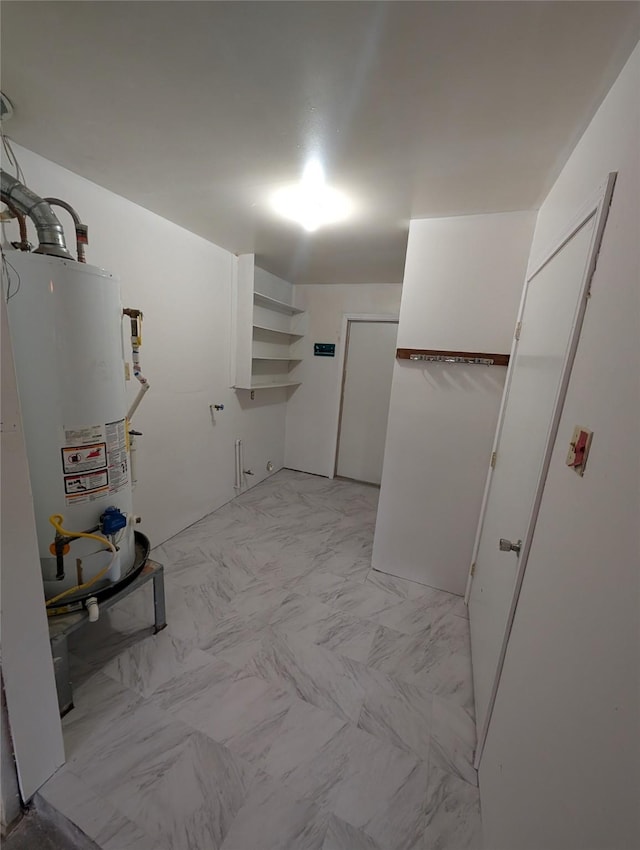 2004 24th St, Galveston, TX 77550 - washroom featuring water heater and light marble finish flooring