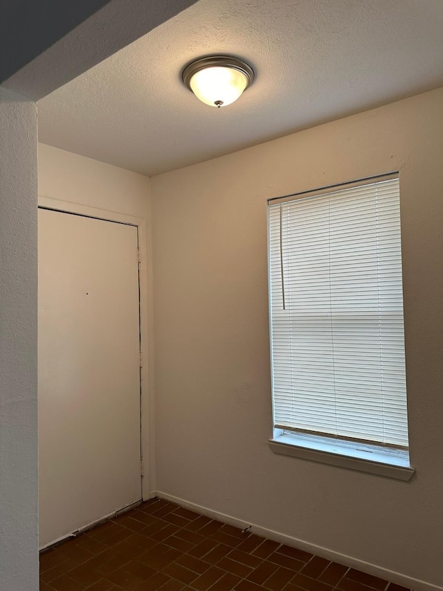 10555 Turtlewood Ct Unit 613, Houston, TX 77072 - unfurnished room with baseboards and a textured ceiling