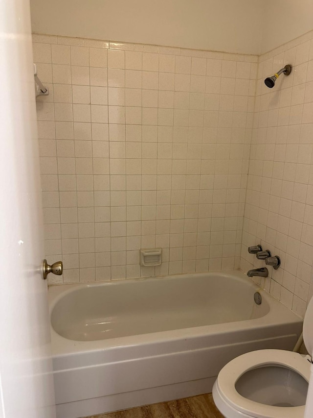 10555 Turtlewood Ct Unit 613, Houston, TX 77072 - bathroom with washtub / shower combination and wood finished floors